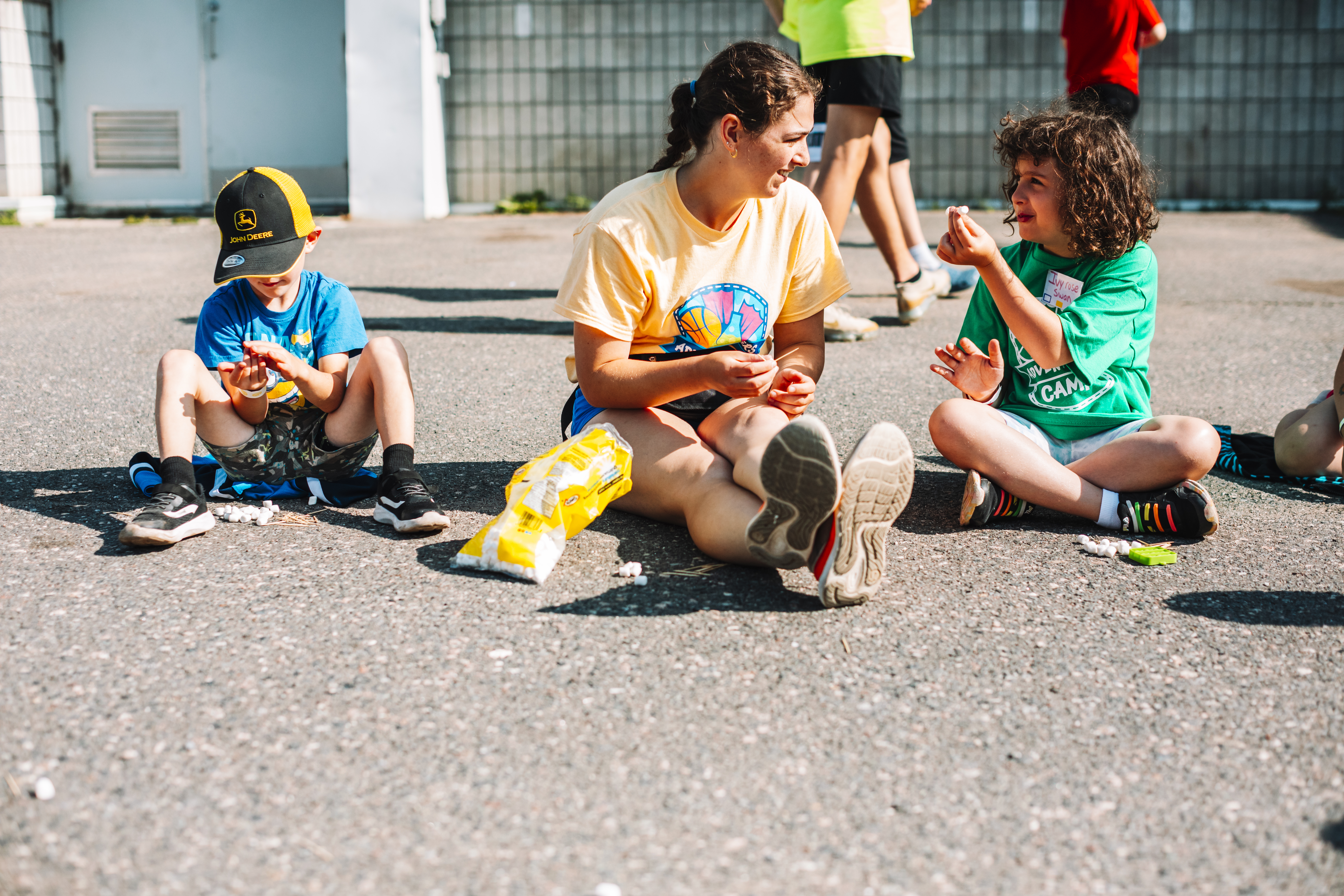 summer camp leader and child playing outside